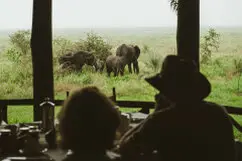 Safari guests watching elephants from Katavi Wildlife Camp during a photographic safari in Tanzania