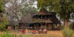 Main lodge building at Katavi Wildlife Camp surrounded by trees and dry wilderness
